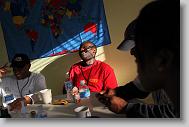 Dieuner Joseph, center, laughs with Tru Pettigrew, left, over breakfast at the mission house at the Global Outreach Compound Monday May 3, 2010, in Titanyen Haiti.  Joseph is one of  a number of volunteers with the North Carolina Baptist Men Haiti Disaster Relief who are spending a week in country.   ETHAN HYMAN  - ehyman@newsobserver.com
