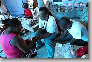 Dr. Kevin Maupin prays with Edlin Emanuel after treating her during  a clinic run by the North Carolina Baptist Men in a church in  Bon Repos, Haiti, Monday May 3, 2010.  ETHAN HYMAN  - ehyman@newsobserver.com