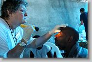 Rebecca Buck from Belhaven checks on Asmeus Jeans during  a clinic run by the North Carolina Baptist Men in a church in  Bon Repos, Haiti, Monday May 3, 2010.  ETHAN HYMAN  - ehyman@newsobserver.com