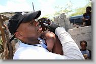 Tru Pettigrew of Cary holds onto Emanula Bathelmy, 2, as he leaves after helping build a shelter for Bathelmy and her family as volunteers with the North Carolina Baptist Men Disaster Relief build houses in Titanyen Haiti Monday May 3, 2010.   ETHAN HYMAN  - ehyman@newsobserver.com
