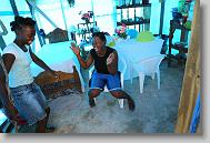 Widline Saint Philppe, right, laughs with Andrise Volcy as they sit in Saint Philippe's home in Titanyen Haiti Monday May 3, 2010. The home is one of dozens that volunteers with the North Carolina Baptist Men Disaster Relief have built in the town.  Four people live in Saint Philippe's home.  She appreciates the home saying she used to get wet when it rained and now the family stays dry.   ETHAN HYMAN  - ehyman@newsobserver.com