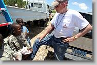 Larry Kingsley of Cary talks with Baba Eliqia, center, Kelvin Sivenr, left, and Junior Seiume, all 7, as volunteers with the North Carolina Baptist Men Disaster Relief build houses in Titanyen Haiti Monday May 3, 2010.   ETHAN HYMAN  - ehyman@newsobserver.com