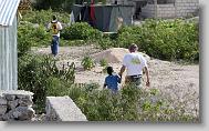 Larry Kingsley of Cary walks with Junior Seiume, 7, as volunteers with the North Carolina Baptist Men Disaster Relief build houses in Titanyen Haiti Monday May 3, 2010.   ETHAN HYMAN  - ehyman@newsobserver.com