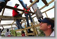 Chris Yarboro watches as Haitians help as volunteers with the North Carolina Baptist Men Disaster Relief build houses in Titanyen Haiti Monday May 3, 2010.   ETHAN HYMAN  - ehyman@newsobserver.com