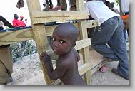 Clerveus Velens, 3, listens to a impromptu sermon after  volunteers with the North Carolina Baptist Men Disaster Relief finished for the day building houses in Titanyen Haiti Monday May 3, 2010.   ETHAN HYMAN  - ehyman@newsobserver.com