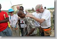 Volunteers with  North Carolina Baptist Men Disaster Relief lay hands on Francois Cetel after he accepted Christ after an invitation at the end of the day while the volunteers were building houses in Titanyen Haiti Monday May 3, 2010.   ETHAN HYMAN  - ehyman@newsobserver.com