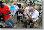 Volunteers with  North Carolina Baptist Men Disaster Relief lay hands on Francois Cetel after he accepted Christ after an invitation at the end of the day while the volunteers were building houses in Titanyen Haiti Monday May 3, 2010.   ETHAN HYMAN  - ehyman@newsobserver.com