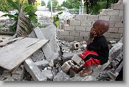 Zikensley Sima looks out at the house next door that collapsed in the earthquake.  Sima is a resident at the Yahve-Jire Children's Foundation in Tabarre,  Haiti Wednesday May 5, 2010.  The orphanage is supported by Western Boulevard Presbyterian Church.  ETHAN HYMAN  - ehyman@newsobserver.com