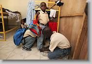 Wilky Maignant helps Deluxon Jean-Brice put on his uniform before school at the Yahve-Jire Children's Foundation in Tabarre,  Haiti Wednesday May 5, 2010.  The orphanage is supported by Western Boulevard Presbyterian Church.  ETHAN HYMAN  - ehyman@newsobserver.com