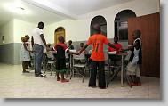 Members gather together in prayer before heading to bed at the Yahve-Jire Children's Foundation in Tabarre,  Haiti Wednesday evening May 5, 2010.  The orphanage is supported by Western Boulevard Presbyterian Church.  ETHAN HYMAN  - ehyman@newsobserver.com