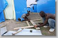 Adrien Wilfrid, left, and Pierre Maxo work on constructing a door for a shelter constructed by Samaritan's Purse in Lafito, Haiti, Thursday May 6, 2010. The camp with rows of shelters and access to latrines and potable water is designed to help reduce the spread of insect borne diseases.  ETHAN HYMAN  - ehyman@newsobserver.com