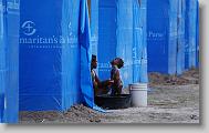 Eliana Isme give her daughter, Maydaline, 2, a bath outside their shelter in Lafito, Haiti, Thursday May 6, 2010. The camp, constructed by Samaritan's Purse, with rows of shelters and access to latrines and potable water is designed to help reduce the spread of insect borne diseases.  ETHAN HYMAN  - ehyman@newsobserver.com