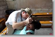 Dr. Bill Harden of Rocky Mount checks on Michele Bernard, 33, during a medical clinic by volunteers with the North Carolina Baptist Men Disaster Relief team in Cabaret, Haiti Friday May 7, 2010.   ETHAN HYMAN  - ehyman@newsobserver.com