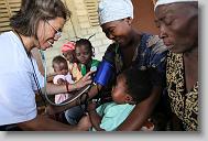 Lolita Upchurch from Raleigh checks the vitals of Maxime Mie Joset and her son Beauvil Frandy, 3 months,  during a medical clinic by volunteers with the North Carolina Baptist Men Disaster Relief team in Cabaret, Haiti Friday May 7, 2010.  ETHAN HYMAN  - ehyman@newsobserver.com