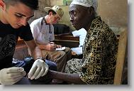 Bryan Winchell with ALERT takes a blood sugar level from Melanie Duvelsaint, 90, during a medical clinic by volunteers with the North Carolina Baptist Men Disaster Relief team in Cabaret, Haiti Friday May 7, 2010.  ETHAN HYMAN  - ehyman@newsobserver.com