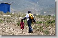 Hans Frazilus from Cary walks with James Dalzo, 6, during the last day  of working in Titanyen for this group of the North Carolina Baptist Men Disaster Relief team in Titanyen, Haiti Friday May 7, 2010.  ETHAN HYMAN  - ehyman@newsobserver.com