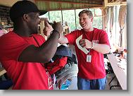 Chris Yarboro of Roxboro, right, says goodbye to Laurent Jones after giving him some clothes during the last working day in Titanyen for this group of the North Carolina Baptist Men Disaster Relief team in Titanyen, Haiti Friday May 7, 2010.  ETHAN HYMAN  - ehyman@newsobserver.com
